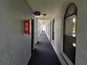 Interior hallway featuring a fire extinguisher, overhead lighting, and carpet at 25210 Northlake Dr # 210, Sanford, FL 32773