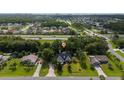 An aerial view of a lovely home in a tranquil neighborhood surrounded by mature trees and lush greenery at 2707 Carmel Ct, Kissimmee, FL 34746