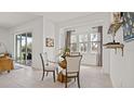 Bright dining area features a modern table, neutral chairs, and sliding doors leading to the outdoor space at 2927 Believe In Yourself Ct, Clermont, FL 34714