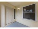 Inviting front porch featuring a classic white door, window and sconce light at 309 Kirkcaldy Dr, Winter Springs, FL 32708