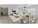 Inviting living room and dining area showcasing tile floors, plantation shutters, and a modern design at 3121 Natoma Way, Orlando, FL 32825