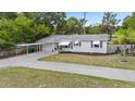 Delightful home with a convenient carport, pristine lawn, and a welcoming facade, ideal for comfortable suburban living at 330 N Stone St, Deland, FL 32720