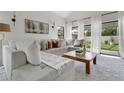 Bright living room with a plush sectional sofa, stylish decor, and large windows at 345 Goldstone Pl, Lake Mary, FL 32746