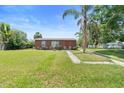Cozy single-story home with a well-manicured lawn and inviting front entrance at 3824 Johnson St, Orlando, FL 32805