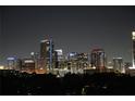 Nighttime view of a vibrant city skyline with brightly lit buildings creating an enchanting urban ambiance at 400 E Colonial Dr # 1103, Orlando, FL 32803
