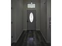 Inviting entryway with wood floors and a front door with decorative glass insert at 508 Bennett St, Auburndale, FL 33823