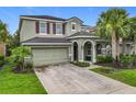 Charming two-story home with a two-car garage, neutral-colored exterior, and well-manicured landscaping at 5255 Wildwood Way, Davenport, FL 33837