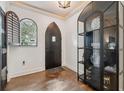 Elegant foyer with dark wood floors, unique display cabinet, and a striking arched window at 602 E Livingston St # 3, Orlando, FL 32803