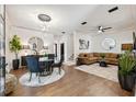 Open-concept living and dining area with stylish furnishings and modern lighting at 602 E Livingston St # 3, Orlando, FL 32803