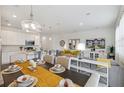 Open concept floor plan featuring kitchen, dining, and living areas with stylish decor and ample natural light at 746 Longboat Dr, Davenport, FL 33896