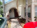 Inviting front entrance with brick walkway and colorful landscaping at 807 Knightsbridge Cir, Davenport, FL 33896