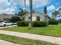 Charming single-story home with lush landscaping and a well-maintained lawn at 807 Knightsbridge Cir, Davenport, FL 33896