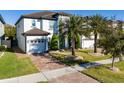 Charming two-story home showcasing a brick driveway, lush lawn, and a two-car garage at 8085 Ludington Cir, Orlando, FL 32836