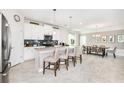Bright and spacious kitchen featuring stainless steel appliances, a central island, and a dining area at 9106 Cut Shot Dr, Winter Garden, FL 34787
