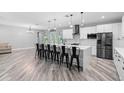 A stylish kitchen with modern appliances, a large island with seating, and an open floor plan, plus lots of natural light at 920 Grand Ave, Orange City, FL 32763