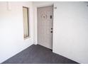 Condo entrance with decorative wreath on door, white walls, and carpeted floor at 952 Courtyard Ln # 41, Orlando, FL 32825