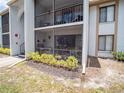 Condo exterior showing a screened balcony and well-maintained landscaping at 952 Courtyard Ln # 41, Orlando, FL 32825