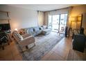 Cozy living room with comfortable seating, neutral decor, and a large window for natural light at 952 Courtyard Ln # 41, Orlando, FL 32825