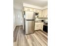 Spacious kitchen featuring stainless steel appliances, granite countertops, and wood-look flooring at 10301 Us Highway 27 # 34, Clermont, FL 34711