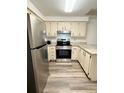Bright kitchen equipped with stainless steel appliances, granite countertops, and wood-look flooring at 10301 Us Highway 27 # 34, Clermont, FL 34711