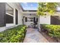 Inviting covered front porch with a stone walkway and dark shutters at 105 Bilsdale Ct, Longwood, FL 32779