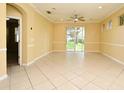 Expansive living area featuring ceramic tile flooring and a ceiling fan, illuminated by natural light at 1086 Wickerwood St, Ocoee, FL 34761