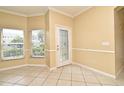 Bright living space with tile flooring, neutral walls, and a glass paneled door to the backyard at 1086 Wickerwood St, Ocoee, FL 34761