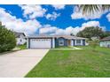 Charming single-story home featuring a well-manicured lawn and a two-car garage at 1115 Marni Ridge Ct, Kissimmee, FL 34747