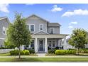 Inviting two-story home with a well-manicured lawn, showcasing a charming exterior and welcoming entrance at 1206 Civitas Way, Winter Garden, FL 34787