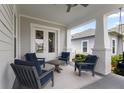 Relaxing covered porch with comfortable seating, perfect for enjoying outdoor living and entertaining at 1206 Civitas Way, Winter Garden, FL 34787