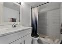 Modern bathroom with gray tile shower, white vanity, and updated fixtures at 126 Scottsdale Sq # 126, Winter Park, FL 32792