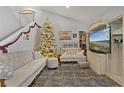 Cozy living room featuring tile floors, comfortable seating, and a bright Christmas tree at 126 Scottsdale Sq # 126, Winter Park, FL 32792
