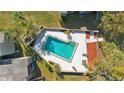 Aerial view of a community pool surrounded by trees and lounge chairs at 126 Scottsdale Sq # 126, Winter Park, FL 32792