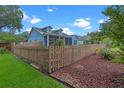 Landscaped backyard with a wood fence at 1407 S Palmetto Ave, Sanford, FL 32771