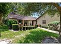Inviting single-story home with manicured hedges, a brick-lined walkway, and lush green lawn at 154 Golf Club Dr # 154, Longwood, FL 32779
