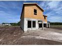 New home construction with block walls and wood framing, set against a blue sky at 1646 Cane Bamboo Drive, St Cloud, FL 34771