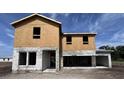 New home construction featuring block walls, wood studs, and an unfinished exterior, with the house framing at 1646 Cane Bamboo Drive, St Cloud, FL 34771