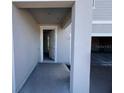 Covered entryway featuring a front door, leading into a home that is currently under construction at 1646 Cane Bamboo Drive, St Cloud, FL 34771
