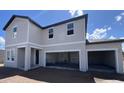 View of a two-story, newly constructed home with an attached three car garage with ample parking at 1646 Cane Bamboo Drive, St Cloud, FL 34771