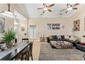Inviting living room with tile floors, ceiling fan, dining area, and comfortable sofa at 182 Westmoreland Cir, Kissimmee, FL 34744