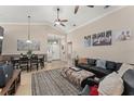 Open-concept living space with tile floors, a dining table, and a cozy seating area at 182 Westmoreland Cir, Kissimmee, FL 34744