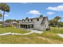 Rear exterior view featuring a screened in porch and fenced in yard at 1836 Se 6Th Ave, Ocala, FL 34471