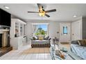 Bright living room features large window, tile flooring, fireplace, and built-in shelving at 2112 Plymouth Sorrento Rd, Apopka, FL 32712