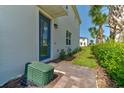 Inviting entryway with a blue front door, brick pathway, and vibrant landscaping, creating a warm welcome at 224 Nine Iron Dr, Davenport, FL 33896