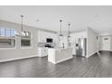 Open kitchen with stainless steel appliances, a center island, and plenty of cabinet space at 2311 Bear Peak Rd, Clermont, FL 34715