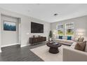 Bright living room with contemporary furniture, large windows, and stylish decor at 2311 Bear Peak Rd, Clermont, FL 34715