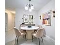 Modern dining room with marble table, plush chairs, and stylish wall art at 2580 Grassy Point Dr # 106, Lake Mary, FL 32746