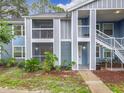 Two-story condo with a screened porch and white stair rails at 2580 Grassy Point Dr # 106, Lake Mary, FL 32746