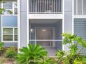 Close up of screened in porch with sliding glass door and lush landscaping at 2580 Grassy Point Dr # 106, Lake Mary, FL 32746