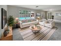 Bright living room featuring stylish furniture, a decorative rug, and a view of the pool at 2710 Wyndham Ln, Orlando, FL 32808